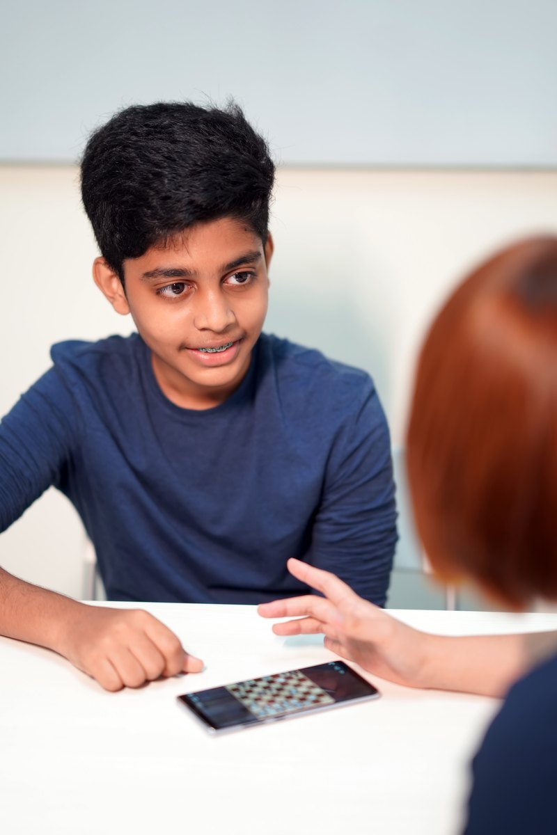 A Genie student talking with their teacher between lessons
